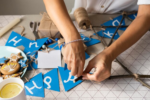 High view person making a happy hanukkah garland