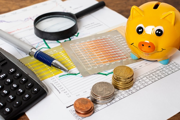 Free photo high view of piggy bank and piles of coins