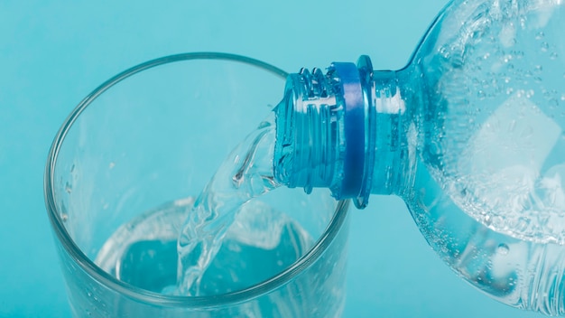 High view pouring sparkling water in glass