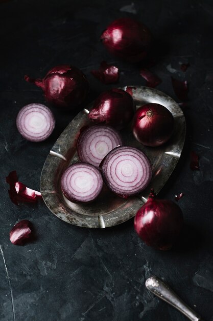 High view red onions on a plate and knife