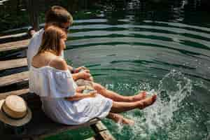 Free photo high view shot of  hugging couple playing in the water