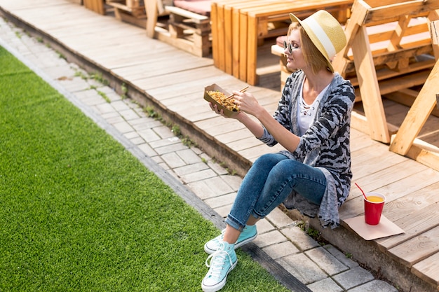 High view shot of a woman holding chinese food