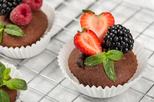 High view tasty cupcake with assortment of forest fruit