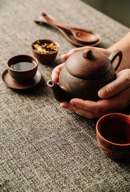 Free photo high view of teapot being held by man