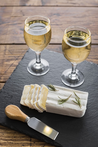 High view white wine glasses and cheese