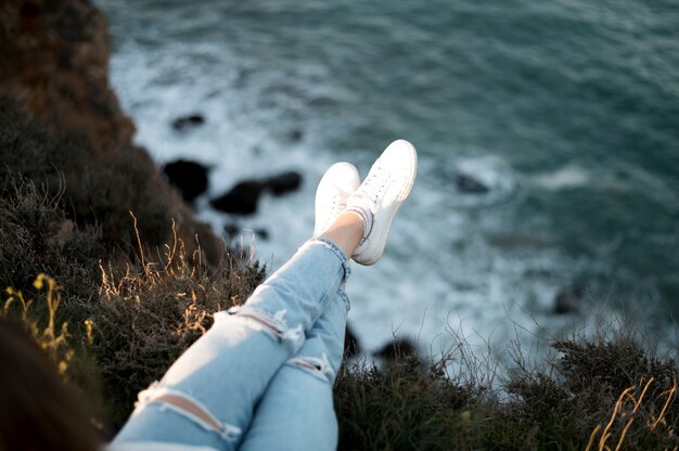 High view woman's legs and ocean