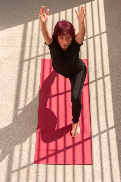 High view woman stretching her back