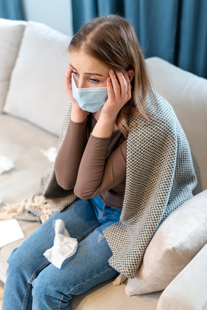 Free photo high view woman with mask and tissues