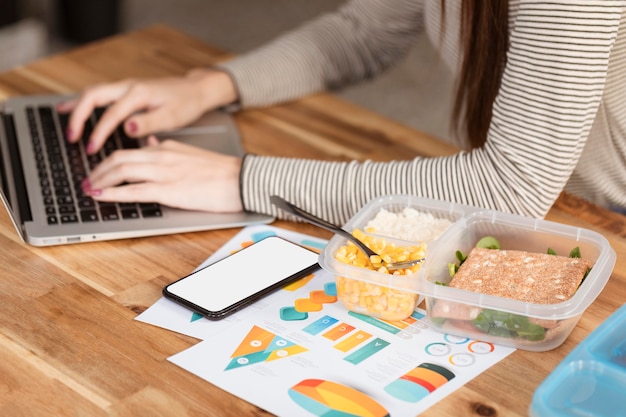 High view woman working and lunch boxes