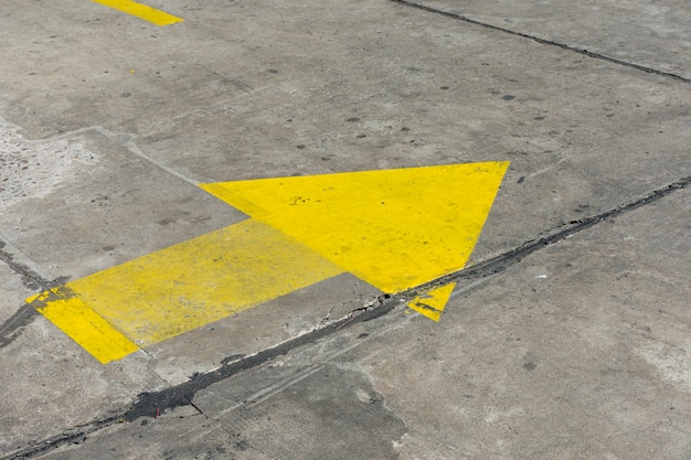 High view yellow painted arrow in the streets