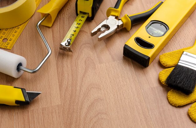 High view yellow repair tools on wooden background