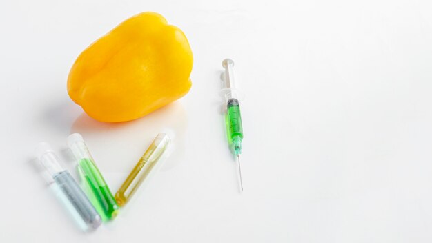 High view yellow sweet pepper and syringe