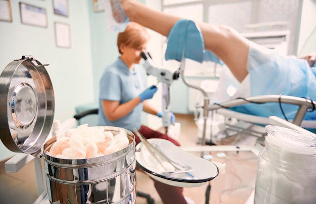 Free photo highly qualified doctor examining woman with colposcope