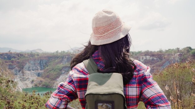 Hiker Asian backpacker woman walking to top of mountain, Female enjoy her holidays on hiking adventure feeling freedom. Lifestyle women travel and relax in free time concept.