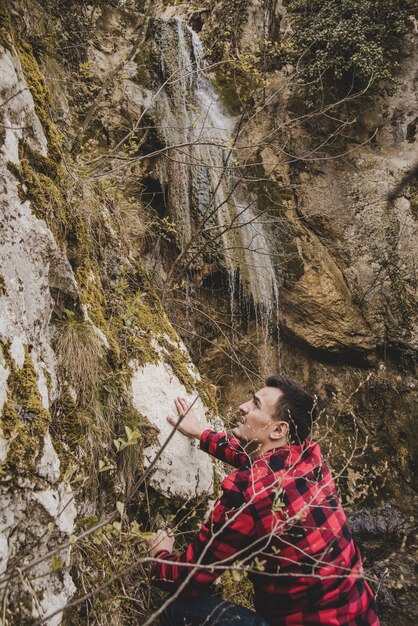 Hiker climbing next to a waterfall