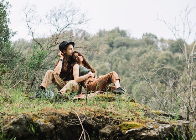 Hiker couple in love sitting in nature