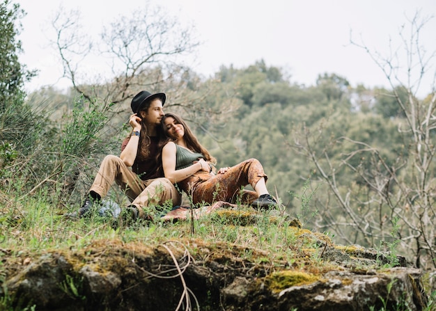 Hiker couple in love sitting in nature