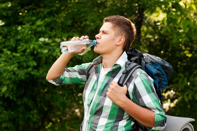 Hiker drinking water in forest