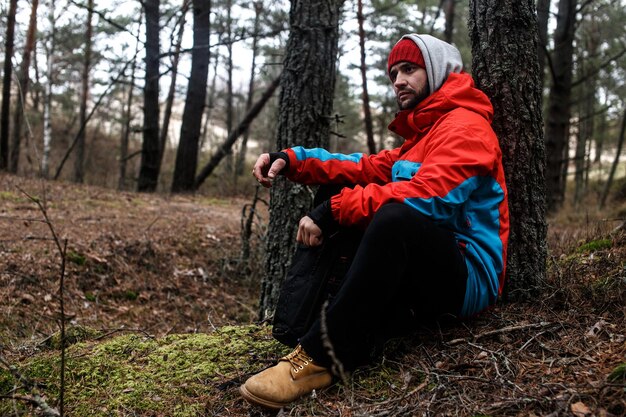 Hiker have short respite on his way in the forest