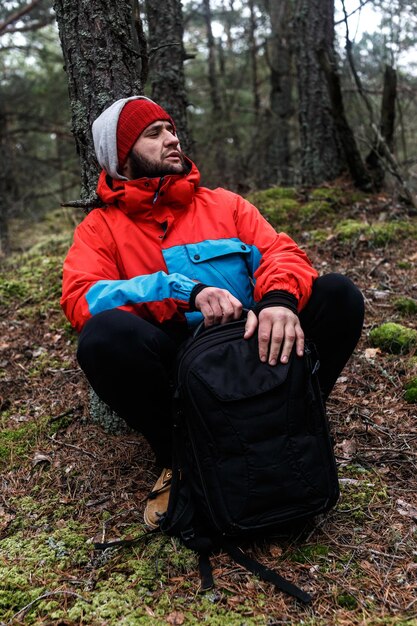 Hiker have short respite on his way in the forest