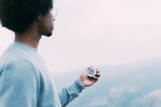 Free photo hiker looking at compass