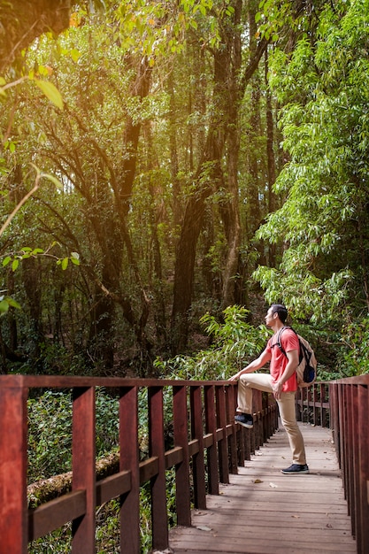 Hiker looking above on an old bridge