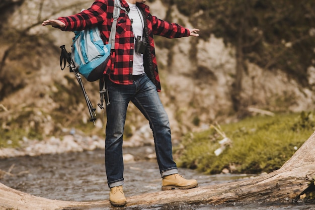 Free photo hiker maintaining balance in the river