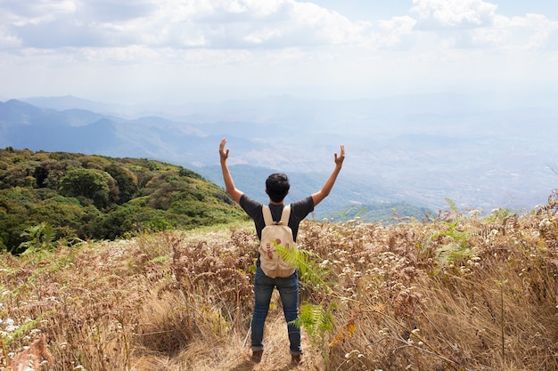 Free photo hiker raising arms