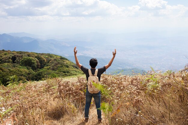 Hiker raising arms