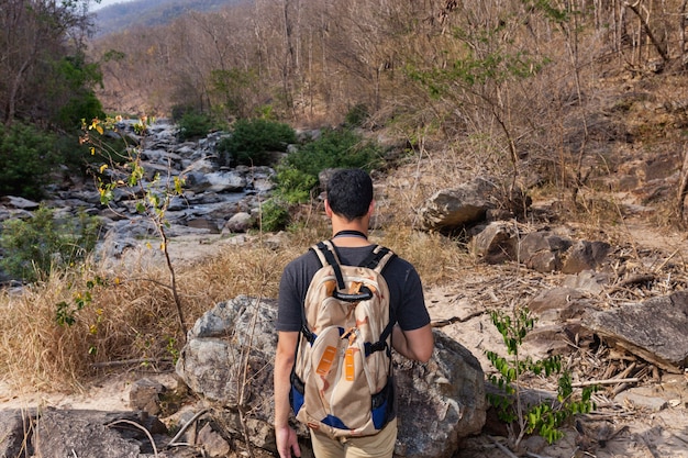 Hiker at river view from back