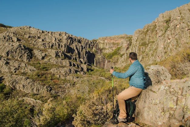 Free photo hiker in rocky environment