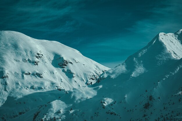 Hiker's view of mountain peaks covered with snow