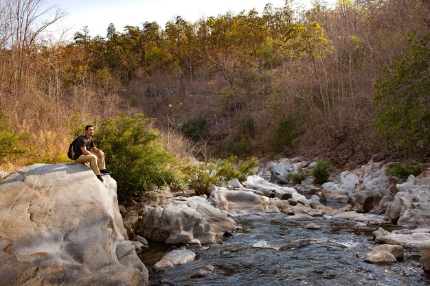 Hiker sitting on big rock