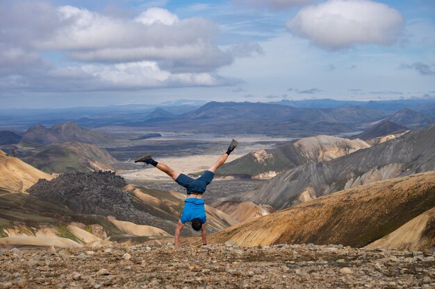 Premium Photo Hiker Standing On His Hand In The Landmannalaugar Valley Iceland Colorful Mountains On The Laugavegur Hiking Trail