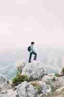 Free photo hiker standing on rock