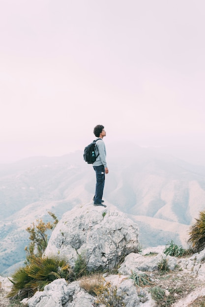 Free photo hiker standing on rock