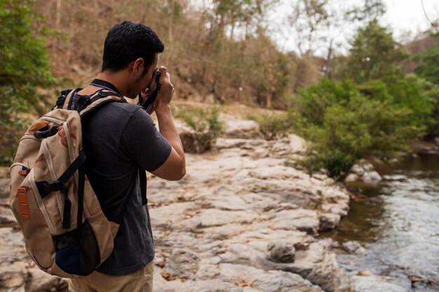Hiker taking photo of river