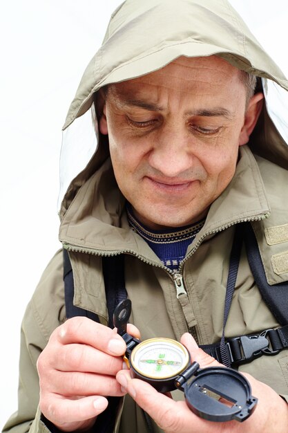 Hiker using compass to know the route