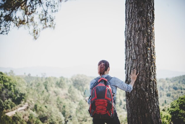 Hiker with backpack on top of a mountain,Freedom and active life concept.