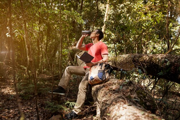 Hiker with book drinking