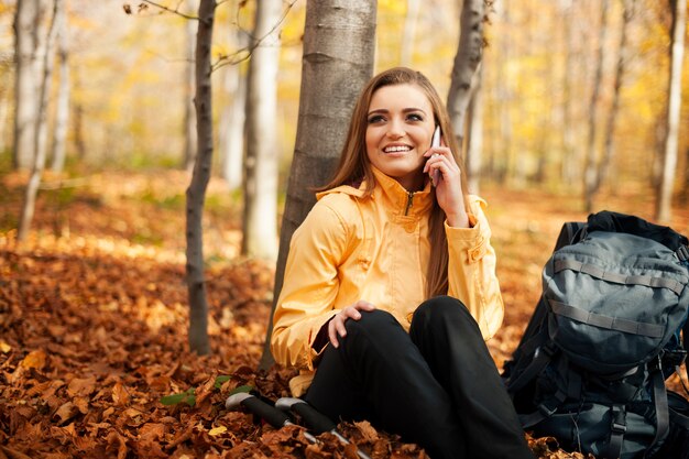 Hiker woman resting and talking on mobile phone