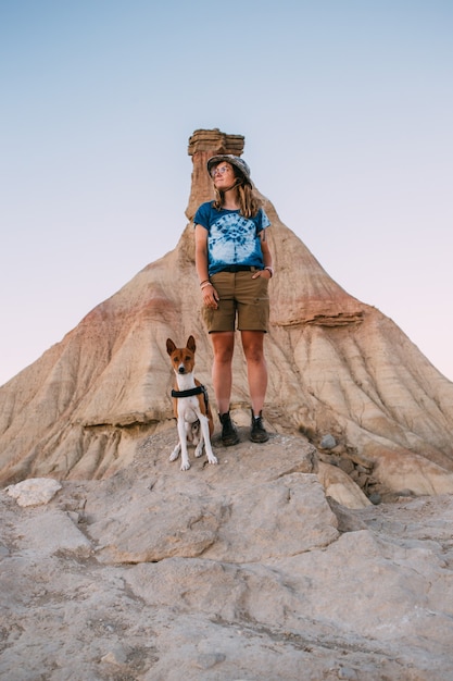 Hiker woman with basenji dog in desert