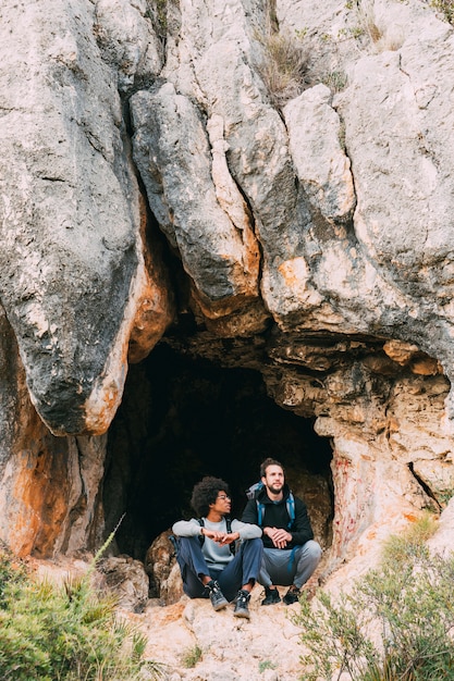 Hikers in front of cave