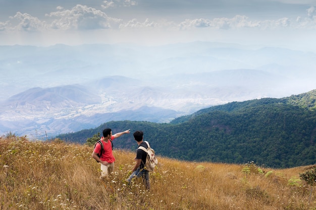 Hikers pointing towards mountains