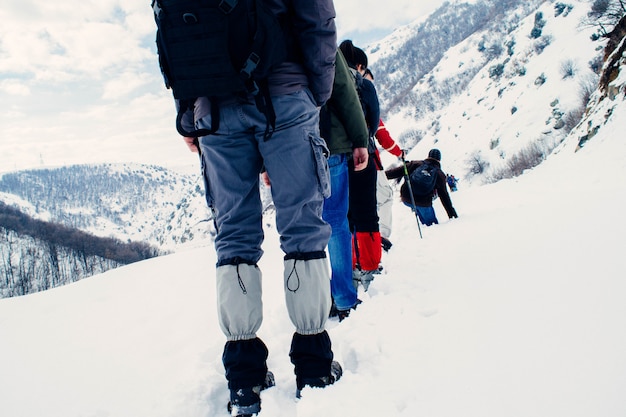 Free photo hikers on a slippery mountain