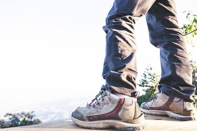 hiking shoes in action on a mountain desert trail path. Close-up of male hikers shoes. 