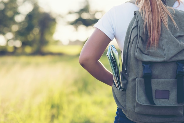 Free photo hiking woman with backpack walking on a gravel road