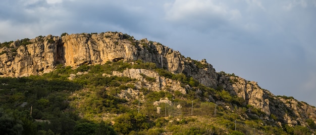 Hill covered in greenery and rocks in the Arrabida Natural Park in Setubal, Portugal