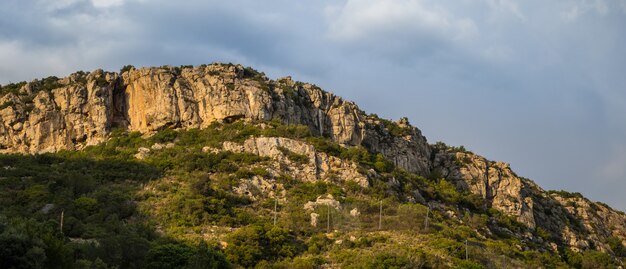 Hill covered in greenery and rocks in the Arrabida Natural Park in Setubal, Portugal