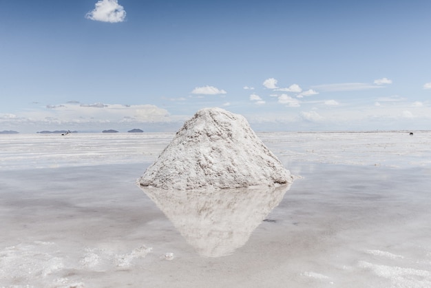 Hill of snow on the frozen lake with the sky